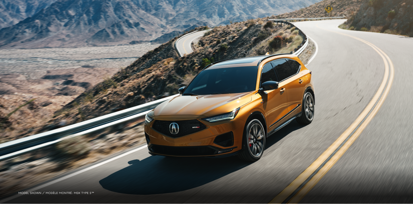 3/4 front view of MDX Type S navigating a chicane on a mountainous highway during the day.